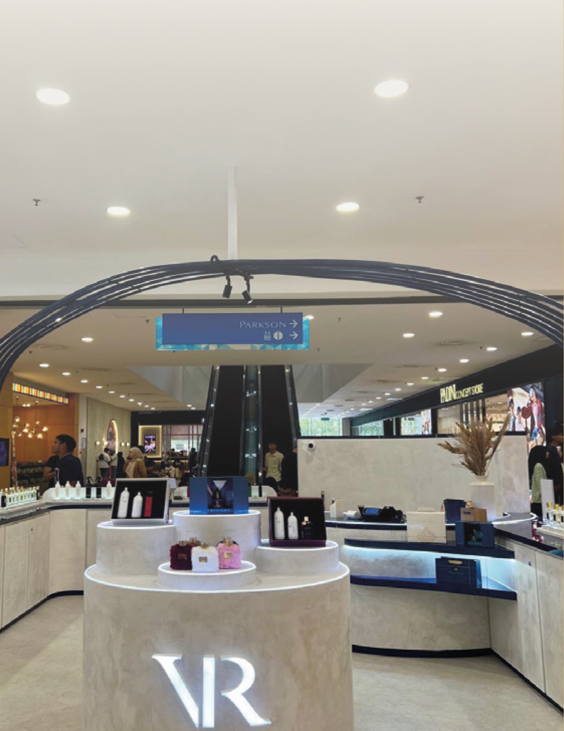 A Vresiana boutique island with a lit VR logo inside a Malaysian mall